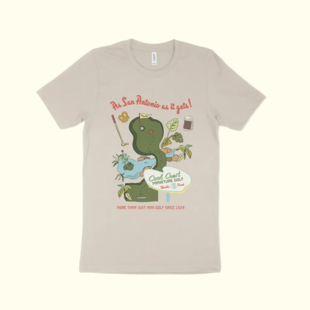 Beige t-shirt with a graphic of a snake and mini golf elements on a white background