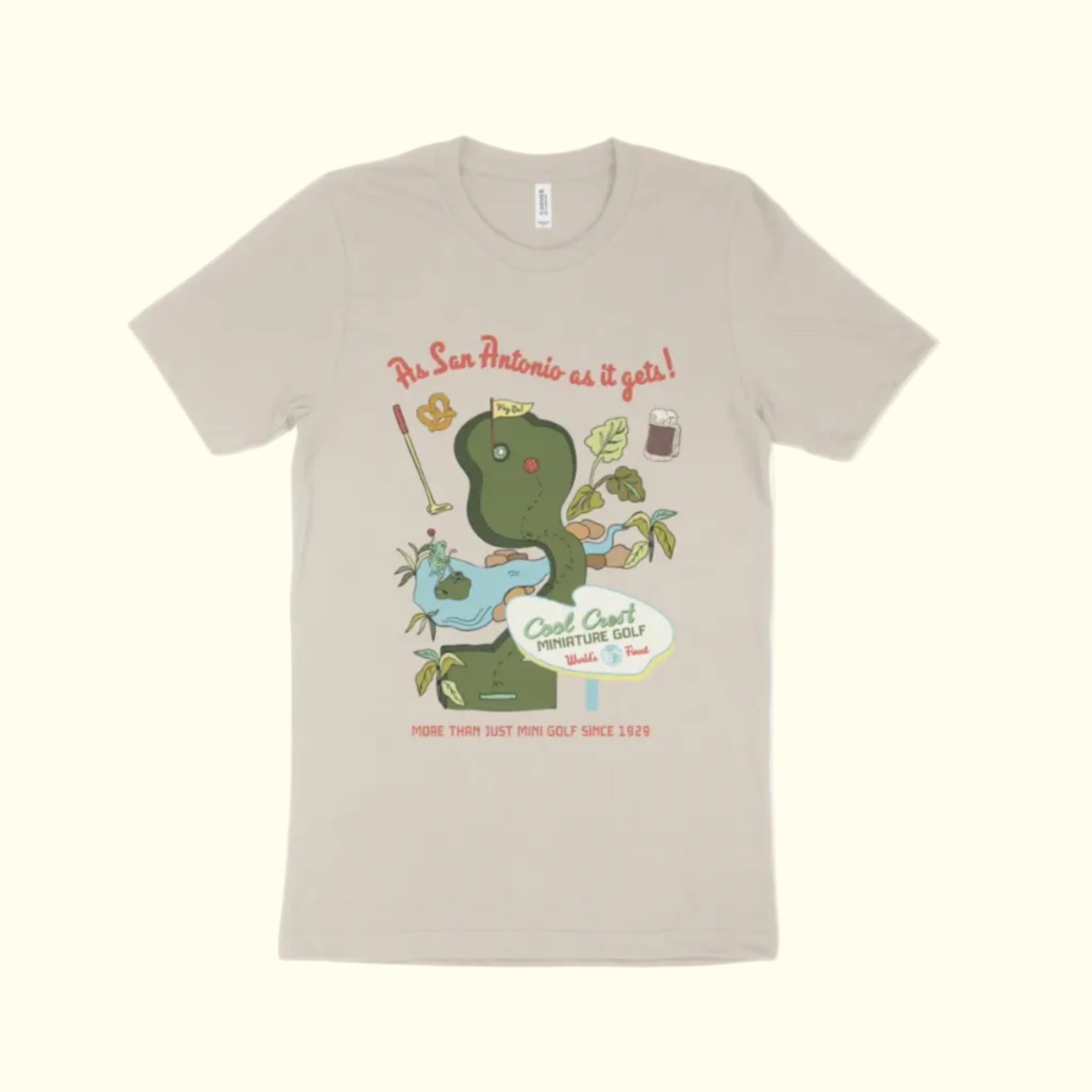 Beige t-shirt with a graphic of a snake and mini golf elements on a white background